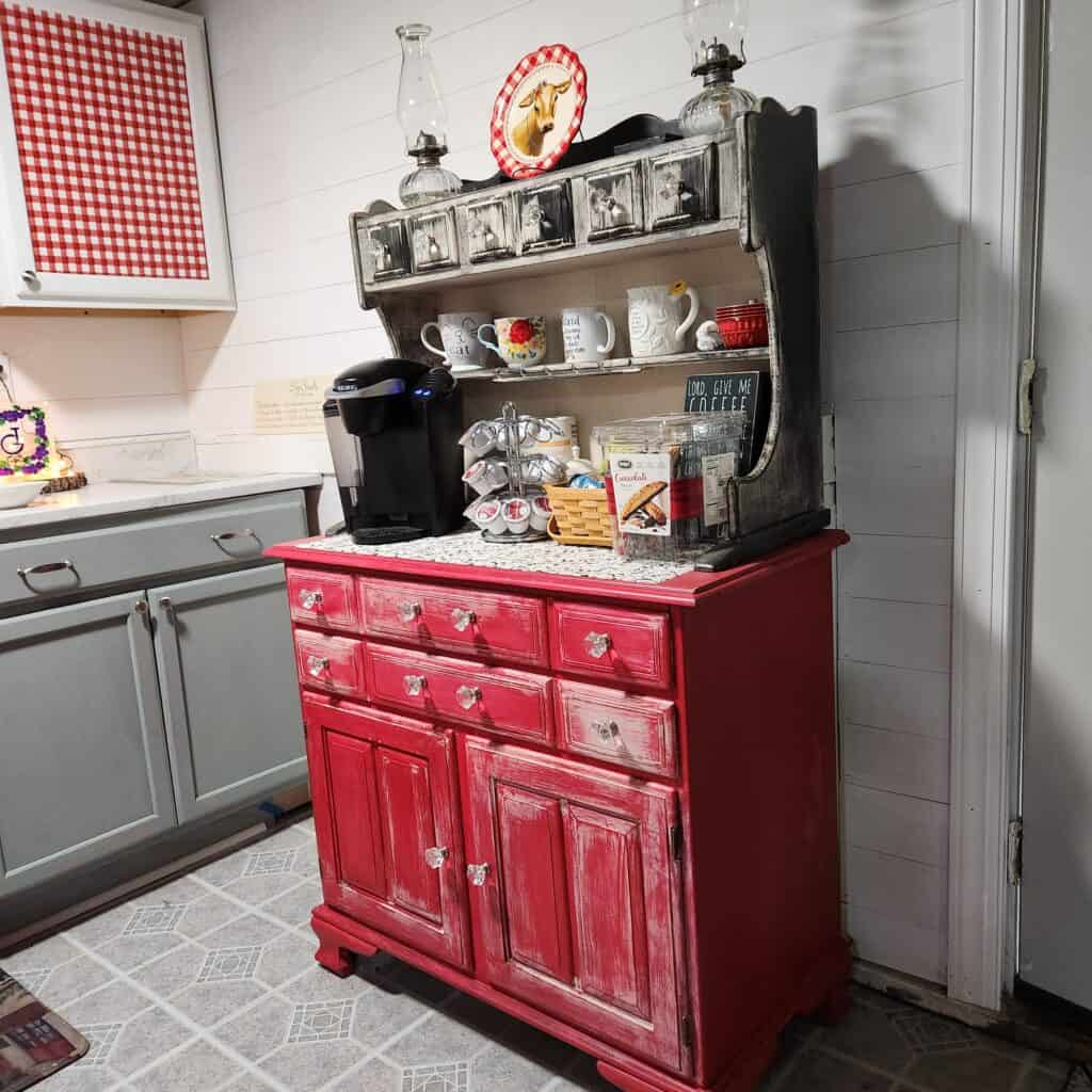 Vintage red cabinet in cozy kitchen interior.