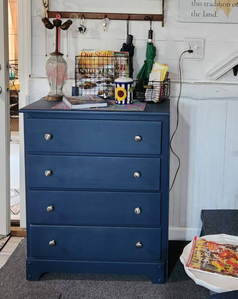 Blue dresser in cozy interior with decorative items.