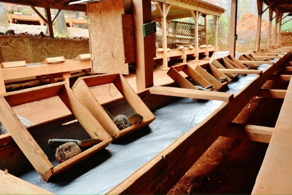 Traditional wooden sluice boxes in gold panning facility.