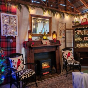 Cozy festive room with fireplace and Christmas decor.